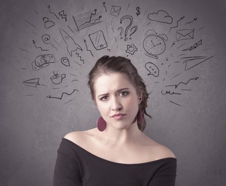 dark-brown-haired-pretty-teenage-girl-631562966 A dark brown haired pretty teenage girl with thoughts in her head illustrated by question mark, rocket, money, coffee, clock, email, social life icons drawn on the background wall concept.