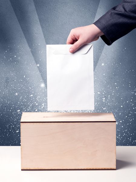 Ballot box with person casting vote on sparkling background