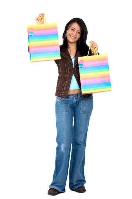 happy girl smiling holding shopping bags - isolated over a white background