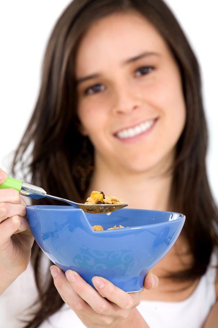 girl eating cereal for her healthy breakfast isolated over a white background