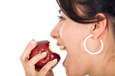 girl biting an apple isolated over white