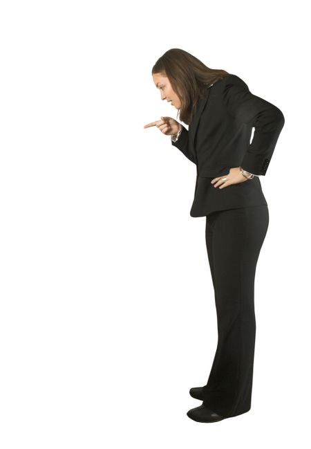 business woman pointing at something as if she was telling someone off