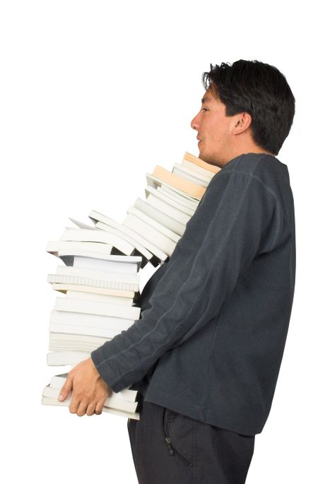 casual guy carrying some books