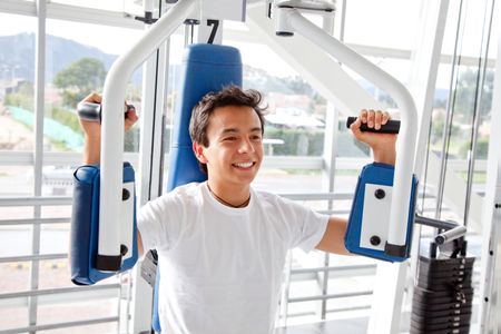 Man at the gym exercising on a machine