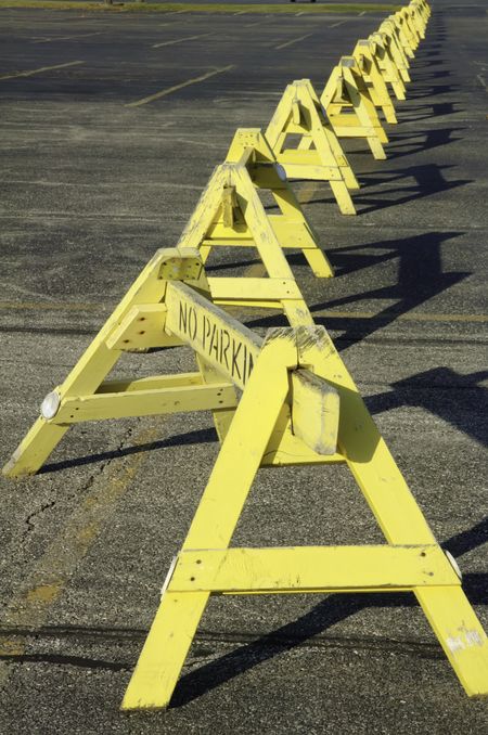 Row of "No Parking" barriers across parking lot