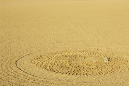 Pattern of rake marks in dirt around pitcher's mound on baseball diamond