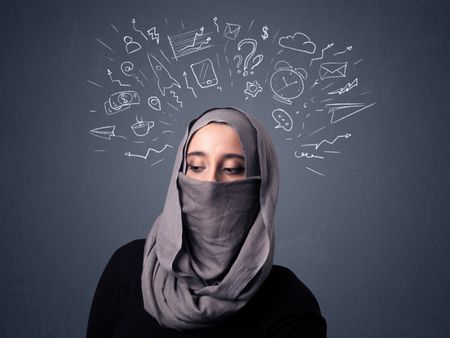 Young muslim woman wearing niqab with mixed white drawings above her head
