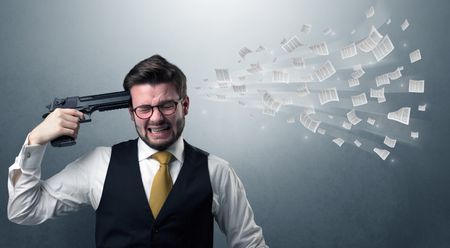 handsome-businessman-shoots-head-gun-documents-635194214 Handsome businessman shoots his head with gun and documents coming out from his head