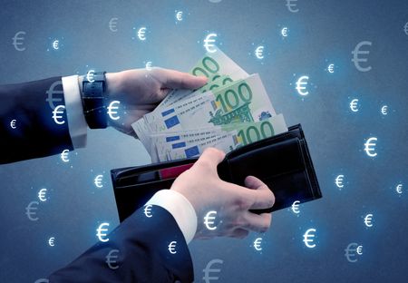 Businessman's hand takes out euro from a wallet with euro symbol wallpaper