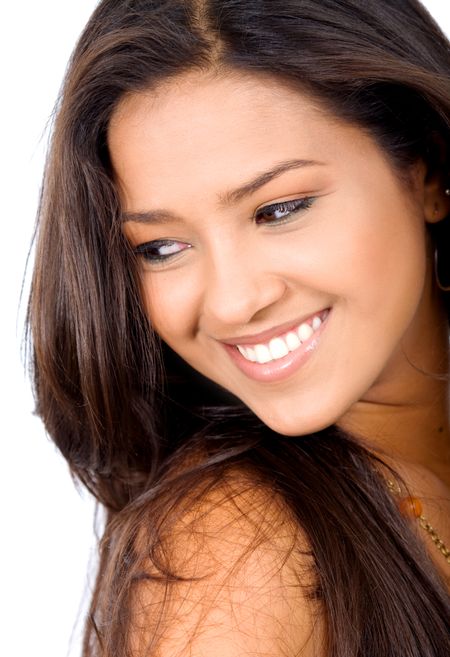 beauty and fashion portrait of a beautiful latin american girl who is smiling and isolated over a white background