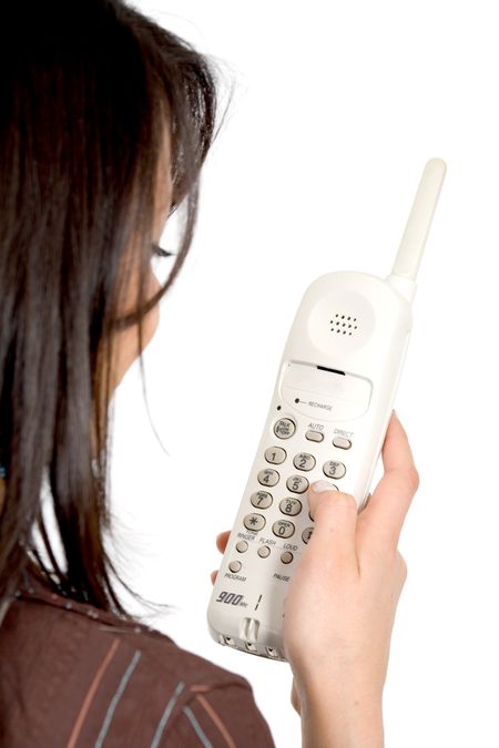 girl dialling on an analogue phone isolated over a white background