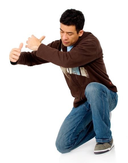 casual man holding something imaginary against the floor