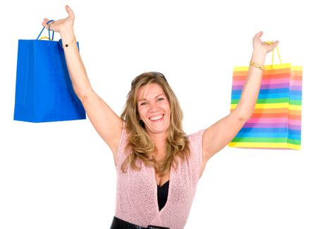 happy woman smiling holding shopping bags - isolated over a white background