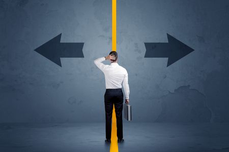 Business person choosing between two options separated by a yellow border arrow concept