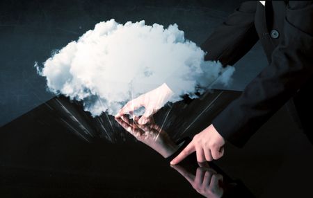 Male hands touching interactive table with a white cloud on it 