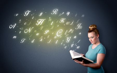 Casual young woman holding book with shiny letters flying out of it