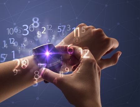 Close up female naked hand wearing smartwatch and numbers around
