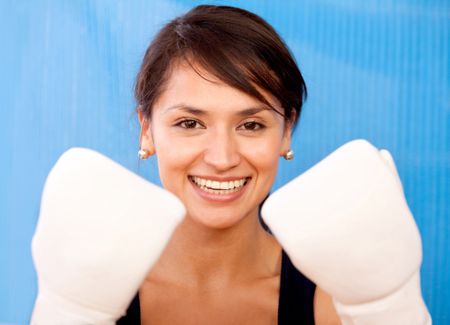 Portrait of a cute female boxer wearing gloves 	