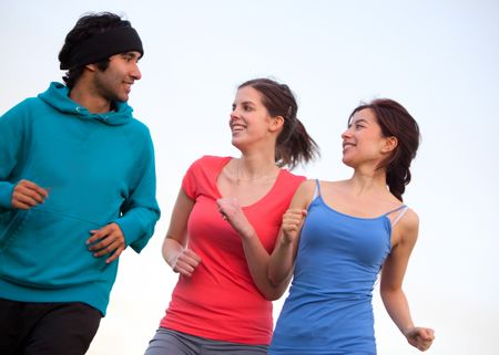 Happy people jogging at the park - fitness concepts