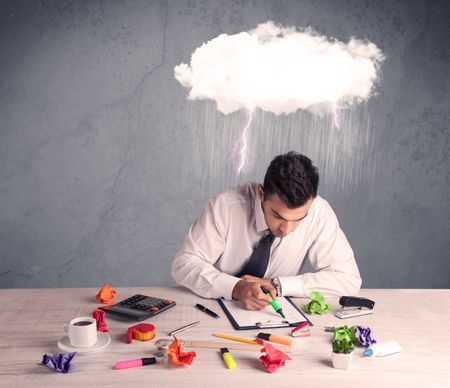 An elegant office worker is having a bad day while working, illustrated by a white cloud above his head with heavy rain and thunder concept