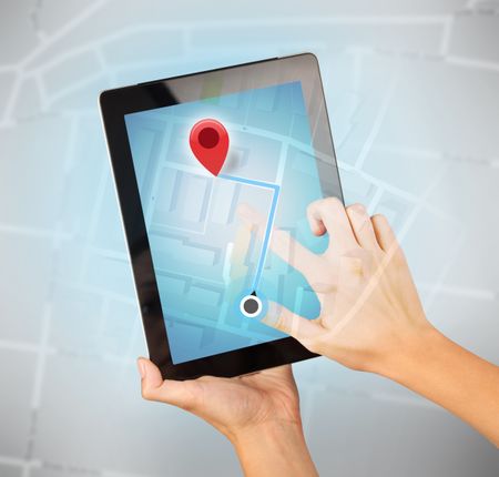 Female fingers touching tablet with map