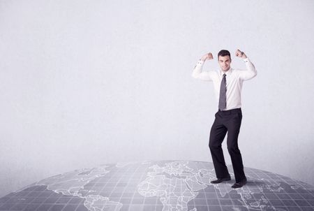 An elegant young male businessman standing on top of the world, pointing up concept with drawn earth map.