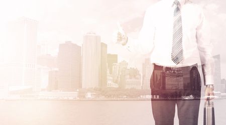 Businessman standing at cityscape background with warm light