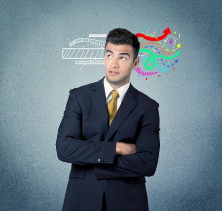 A handsome sales person standing in front of a blue  urban concrete wall with illustration expressing creativity by transforming white lines to colorful arrows cocncept
