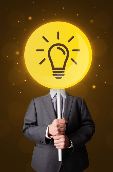 Smart businessman holding round sign with yellow lightbulb