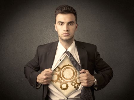 Businessman tearing shirt off and machine cog wheel shows on his chest concept on background