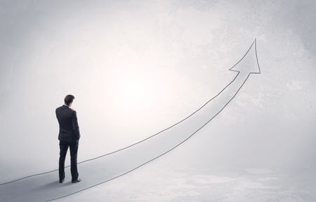 Adult elegant male with briefcase standing on drawn grey arrow pointing up financial concept