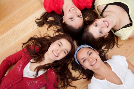 Group of girls lying on the floor with their heads together