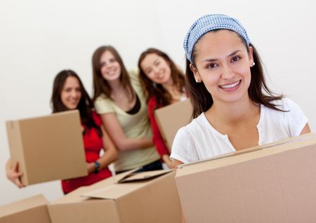 Group of girls with cardboard boxes moving to a new house.