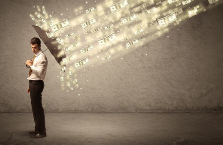 Business man holding umbrella against dollar rain concept on grungy background