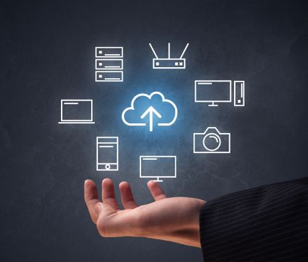 Cloud and computing related icons hovering over young hand 