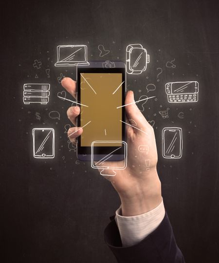 Caucasian hand in business suit holding a smartphone with hand-drawn icons