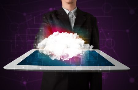 Casual businessman holding tablet with cloud icon and purple background