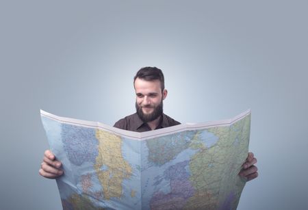 Handsome young man holding map 