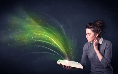 Casual young woman holding book with green wave flying out of it