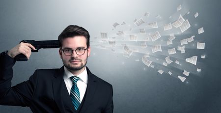 Handsome businessman shoots his head with gun and documents coming out from his head
