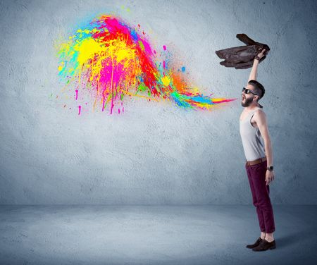 funny-hipster-person-casual-urban-clothing-644344240 A funny hipster person in casual urban clothing shouting bright colorful paint on city wall concept