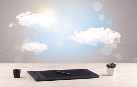 Close up of business office desk concept with clouds, blue sky and sunshine