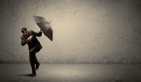 Handsome business man holding umbrella with copy space background concept
