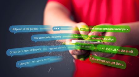 Young man writing messages with smartphone application 