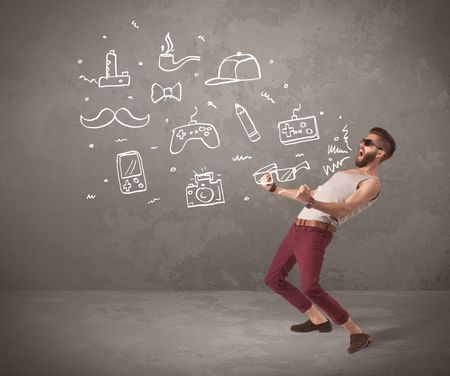 A funny hipster person in casual urban clothing shouting drawn everyday items like camera, tie or pen on city wall concept