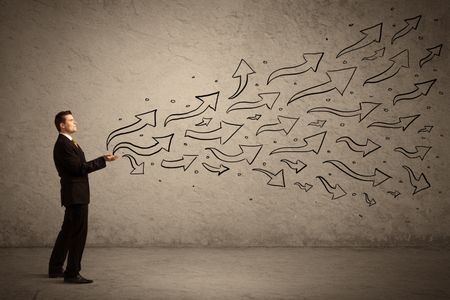 caucasian-businessman-holding-black-drawn-arrow-645097225 Caucasian businessman holding black drawn arrow symbols