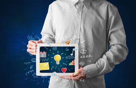 Casual businessman holding tablet with colorful apps