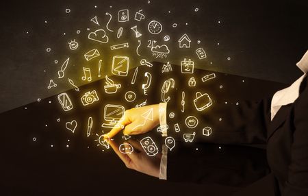 Male hands touching interactive table with yellow mixed media icons on it