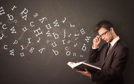 Casual young man holding book with white alphabet flying out of it