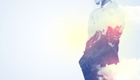 Businessman standing and thinking with snowy mountain graphic